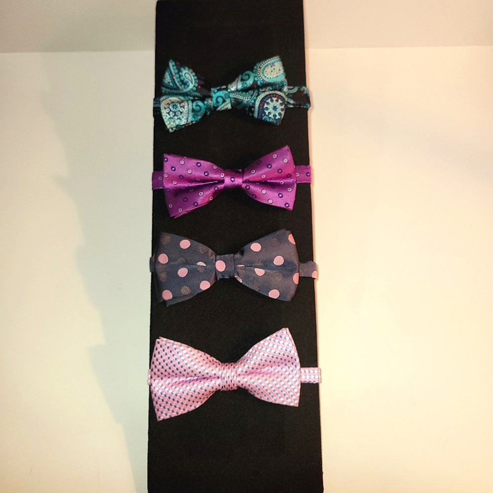 4 pre-tied bow ties in purple, blue, pink, and black.